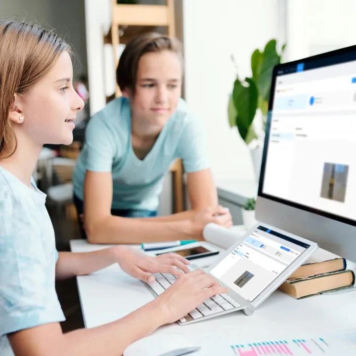 Two learners using a computer to explore the AI Camera.