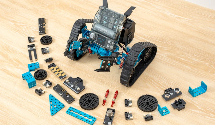 mBot2 Rover and its mechanical construction parts on a wooden table